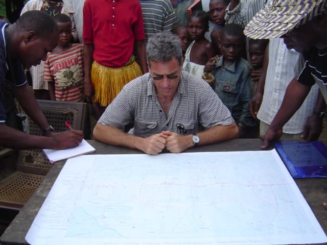 Michael Brown reviewing a map with community members in the field